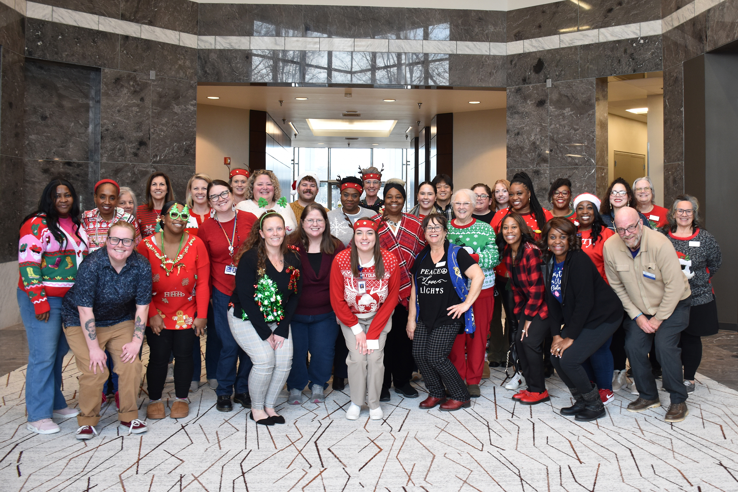 Group Photo of People standing and a sign saying Memory Cafe